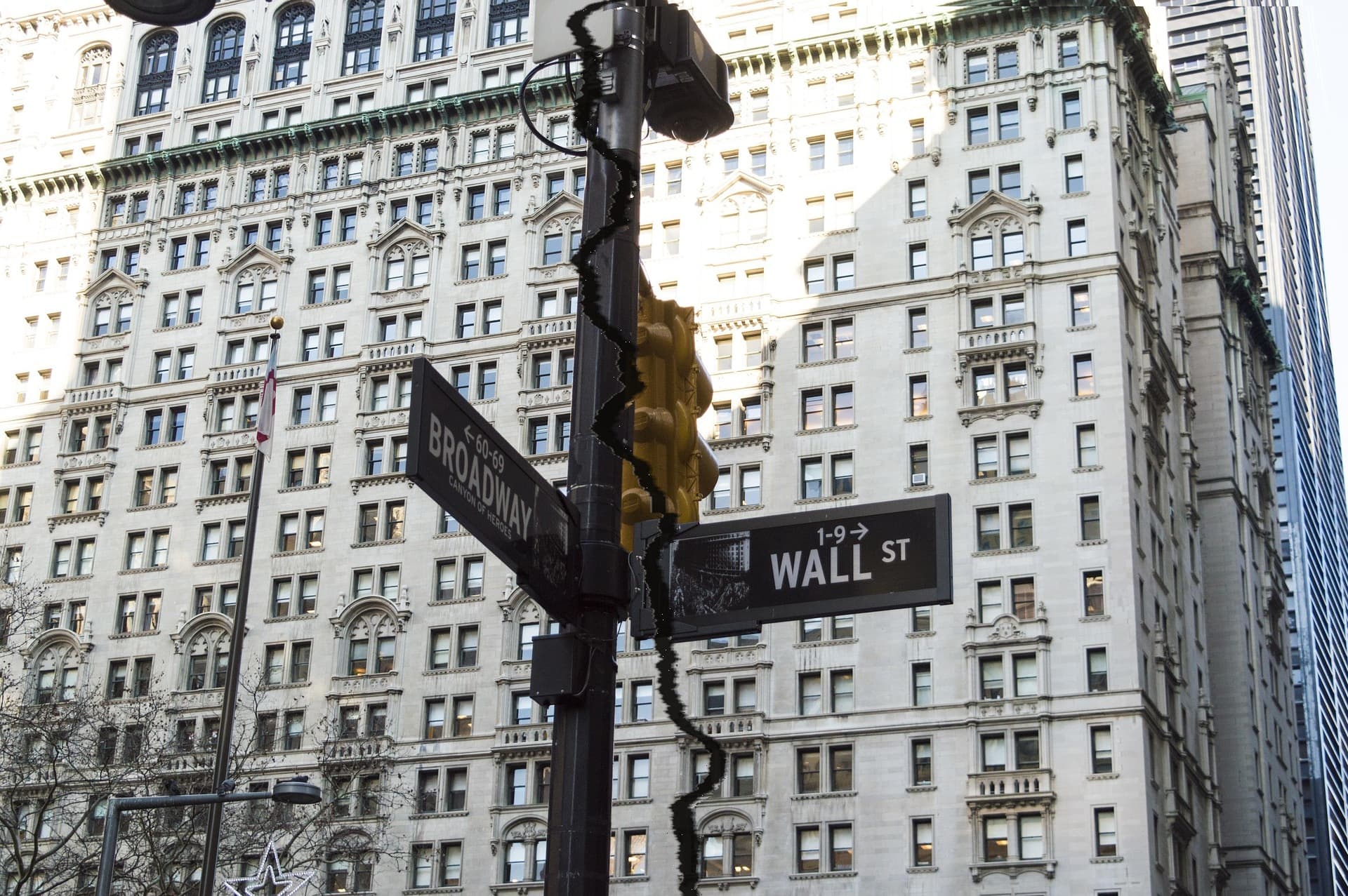 The Wall Street sign at Broadway, the photograph torn through.